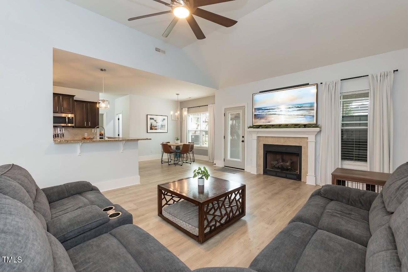 91 Colson Drive Garner, NC 27529 - Photo 10 of 46 a living room with furniture a fireplace and a flat screen tv
