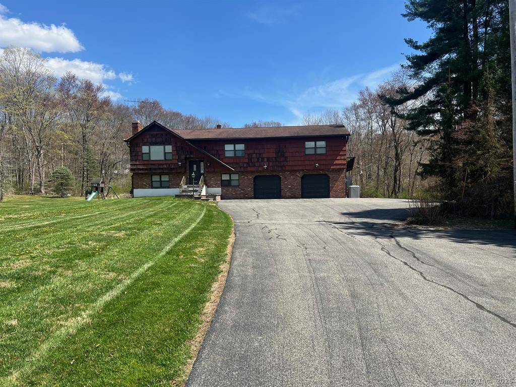 a view of a house with backyard porch and sitting area
