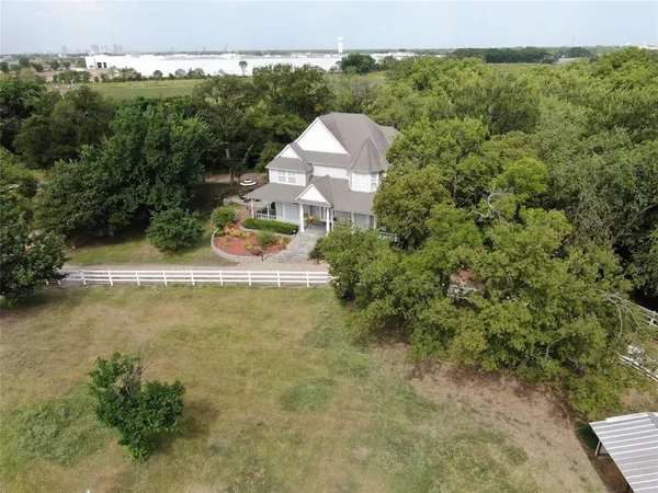 an aerial view of a house with swimming pool and mountains