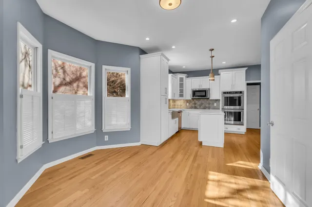 a large kitchen with stainless steel appliances granite countertop a refrigerator and a sink