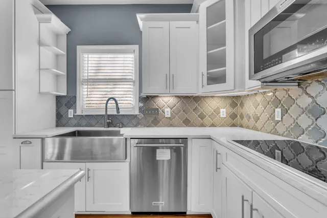 a kitchen with granite countertop a sink and cabinets