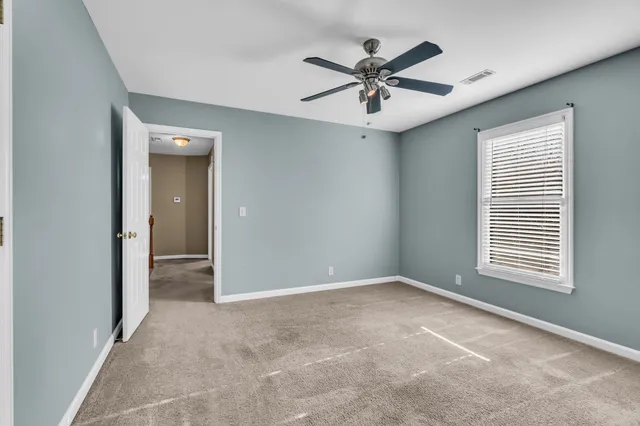 a view of a livingroom with a ceiling fan and window