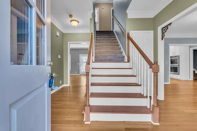 a view of entryway and hall with wooden floor