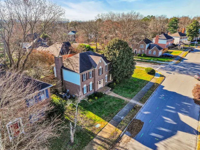an aerial view of multiple houses with yard