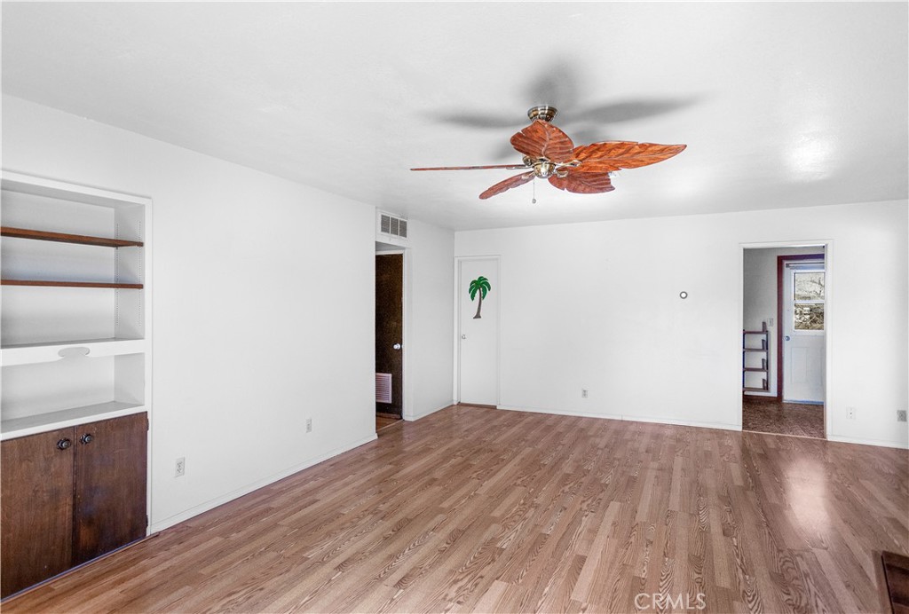 63542 Jadeite Street Joshua Tree, CA 92252 - Photo 5 of 37 wooden floor in an empty room with a window
