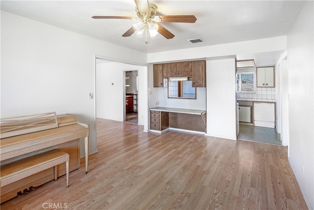 63542 Jadeite Street Joshua Tree, CA 92252 - Photo 10 of 37 a view of a livingroom with wooden floor and a ceiling fan