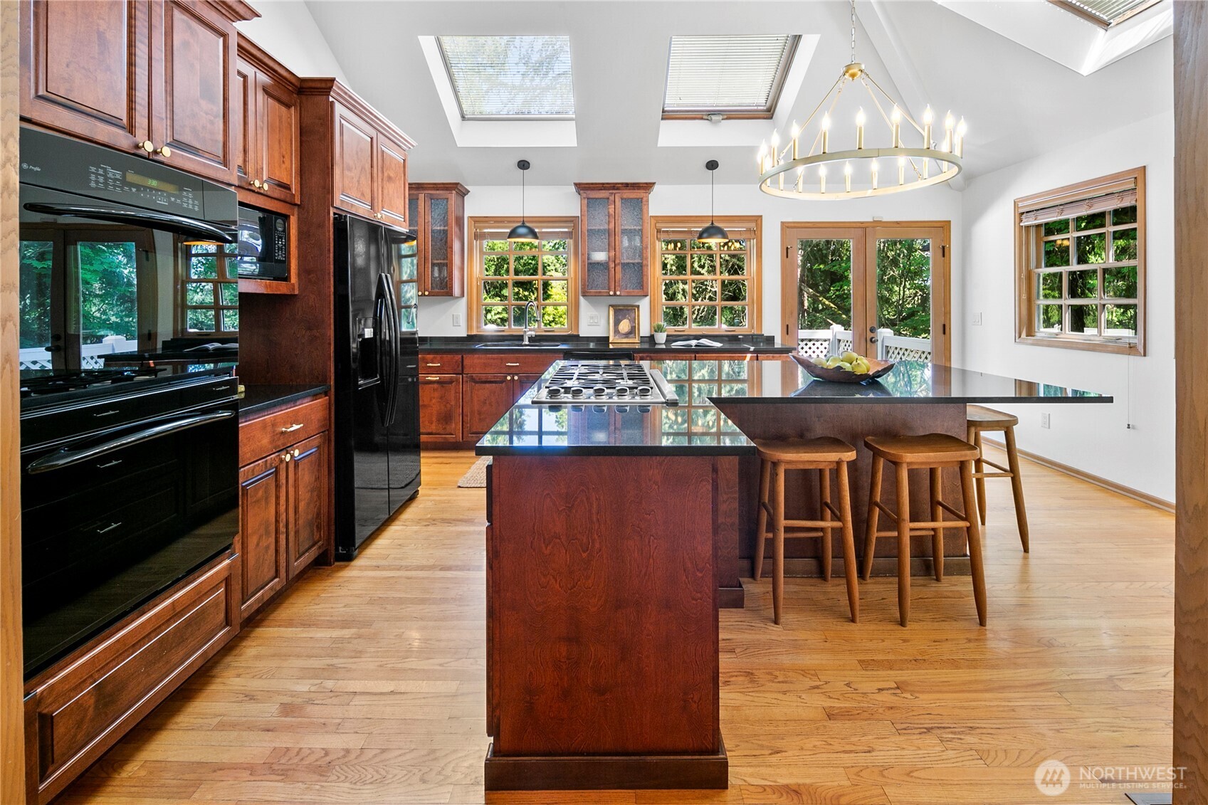 2020 Evergreen Point Road Medina, WA 98039 - Photo 8 of 38 a kitchen with stainless steel appliances granite countertop a stove top oven a sink dishwasher and cabinets with wooden floor