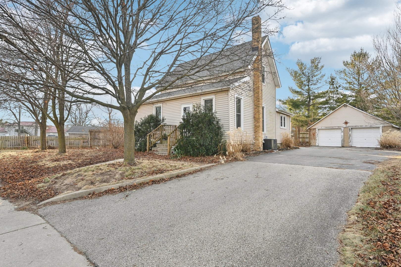 a view of a house with a yard and garage