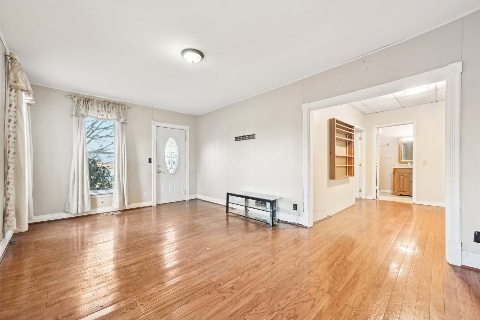 214 South Prospect Street Marengo, IL 60152 - Photo 3 of 37 an empty room with wooden floor and windows