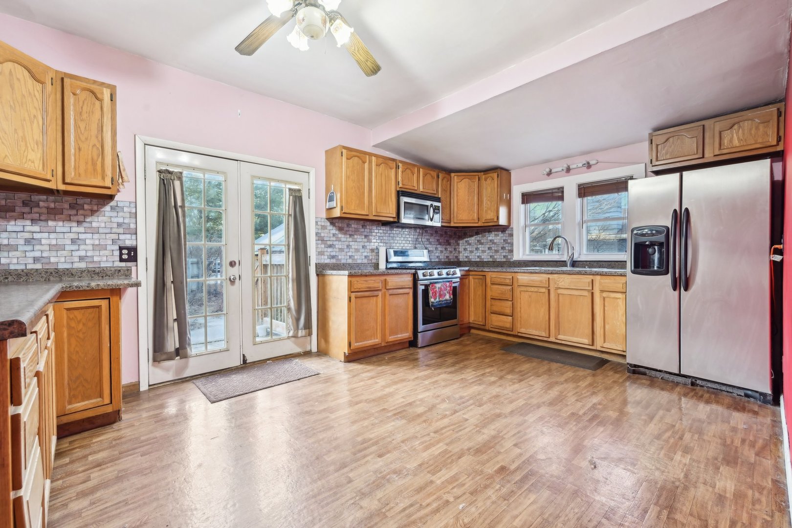 214 South Prospect Street Marengo, IL 60152 - Photo 4 of 37 a kitchen with stainless steel appliances granite countertop a refrigerator a stove and a sink with cabinets
