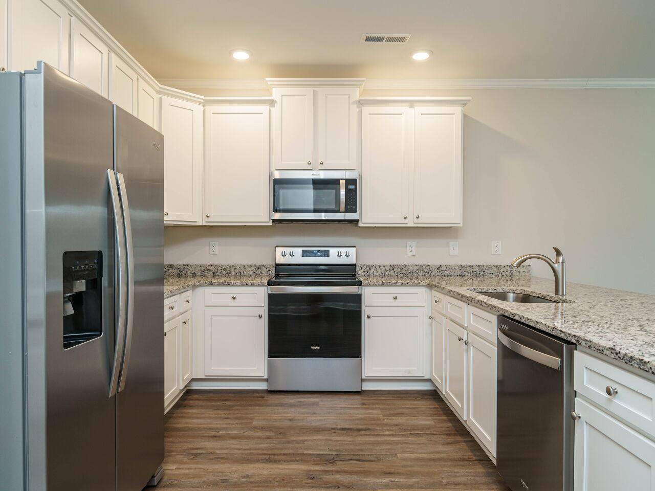 6914 Eddy Point Lane Raleigh, NC 27616 - Photo 15 of 33 a kitchen with stainless steel appliances granite countertop a stove a refrigerator and a sink