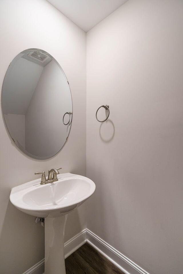6914 Eddy Point Lane Raleigh, NC 27616 - Photo 16 of 33 a bathroom with a sink and mirror