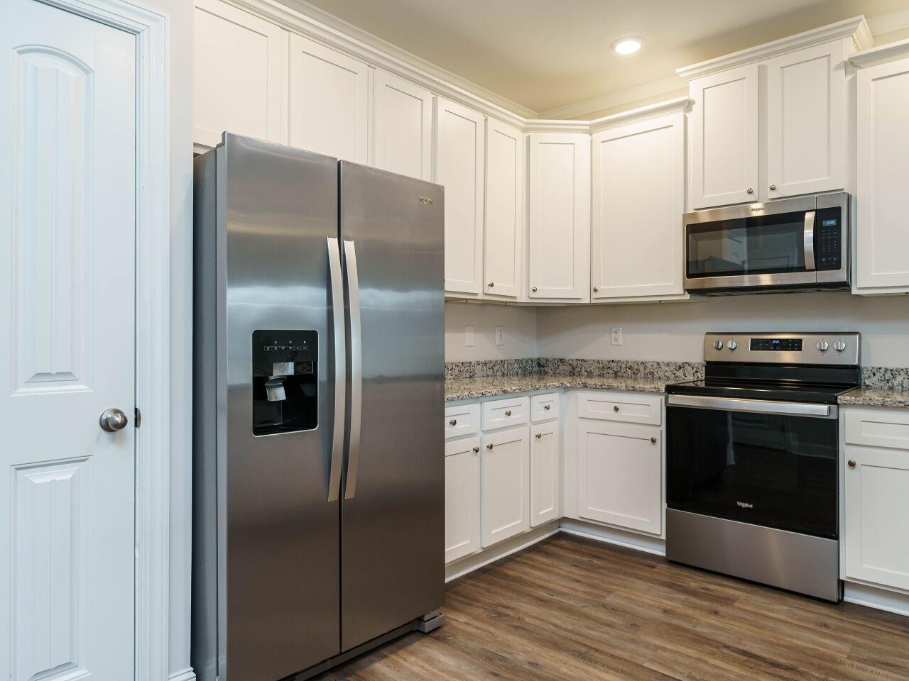 6914 Eddy Point Lane Raleigh, NC 27616 - Photo 17 of 33 a kitchen with stainless steel appliances granite countertop a refrigerator stove and microwave