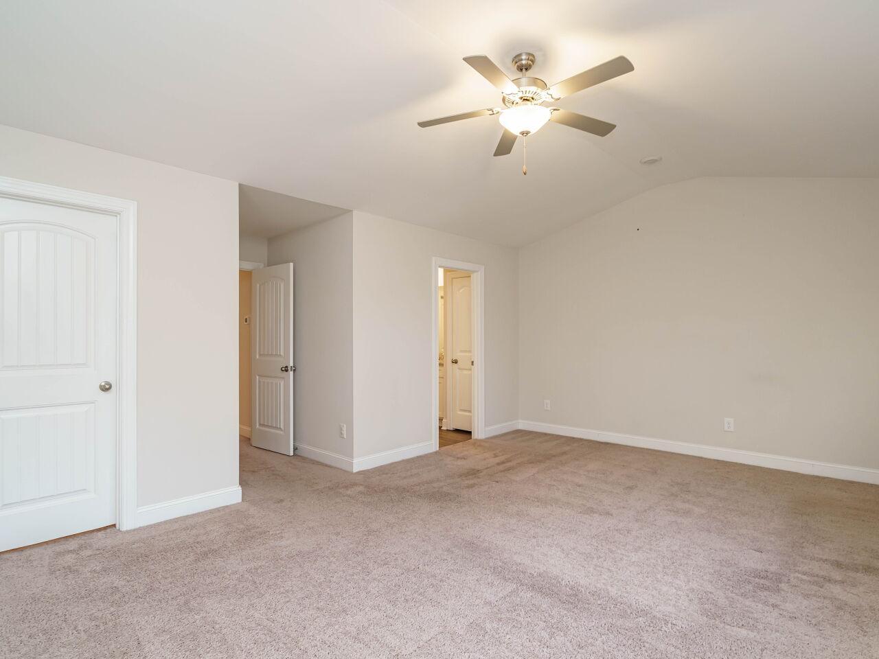 6914 Eddy Point Lane Raleigh, NC 27616 - Photo 21 of 33 an empty room with closet and a ceiling fan