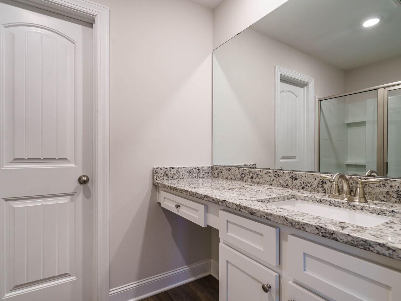 6914 Eddy Point Lane Raleigh, NC 27616 - Photo 23 of 33 a bathroom with a granite countertop sink and a mirror