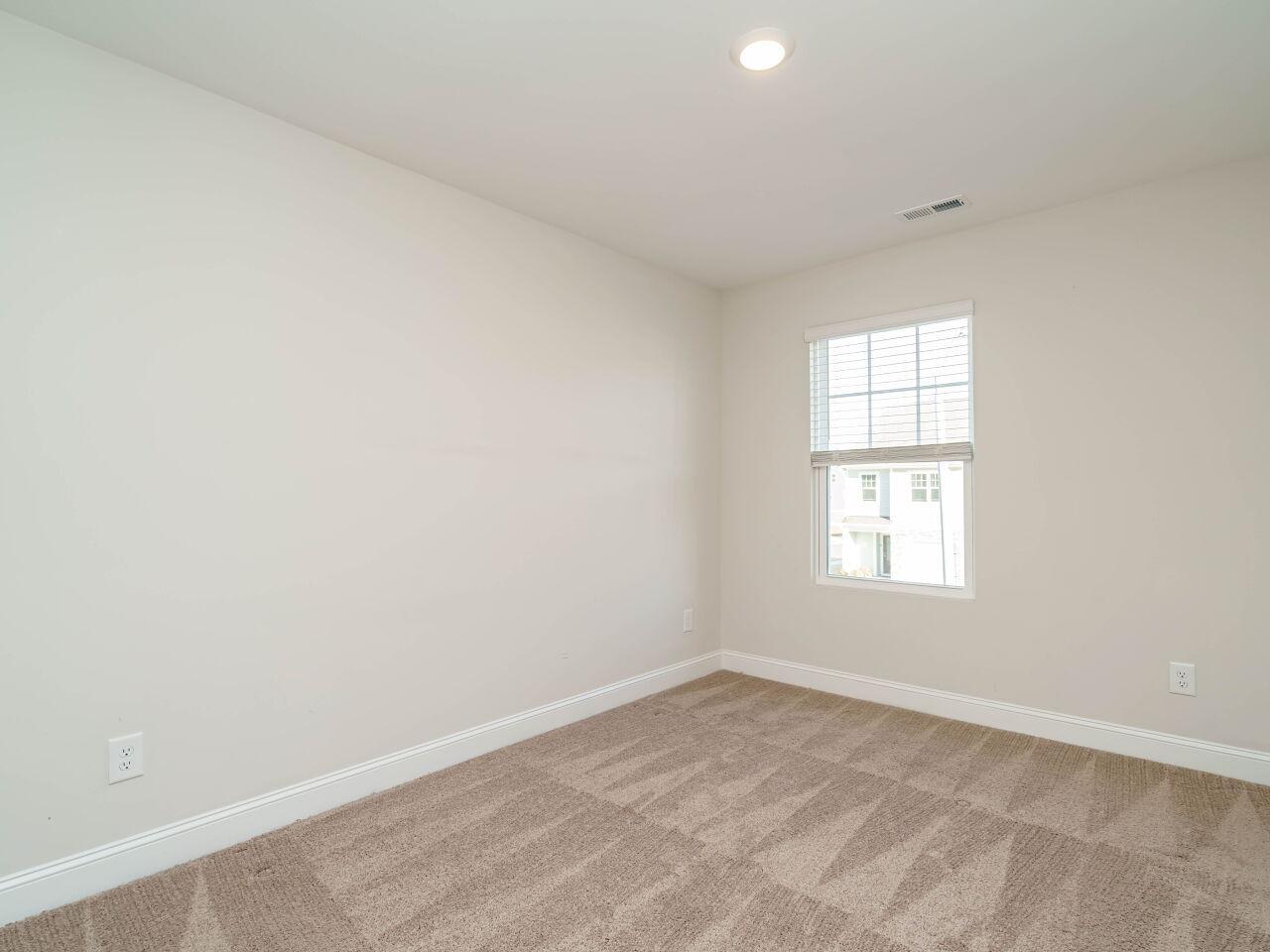 6914 Eddy Point Lane Raleigh, NC 27616 - Photo 27 of 33 an empty room with a window