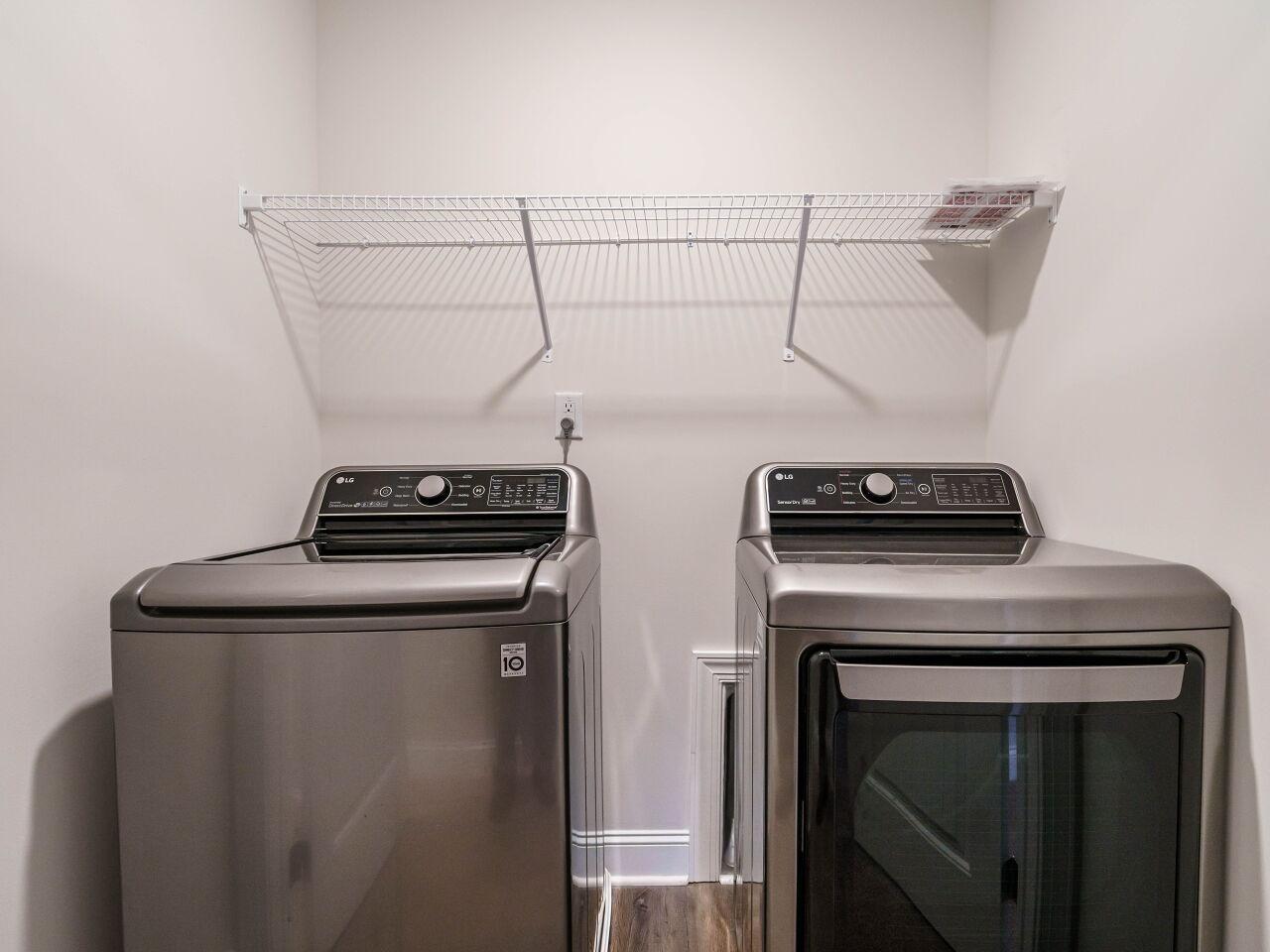 6914 Eddy Point Lane Raleigh, NC 27616 - Photo 28 of 33 a view of storage and utility room with washer and dryer