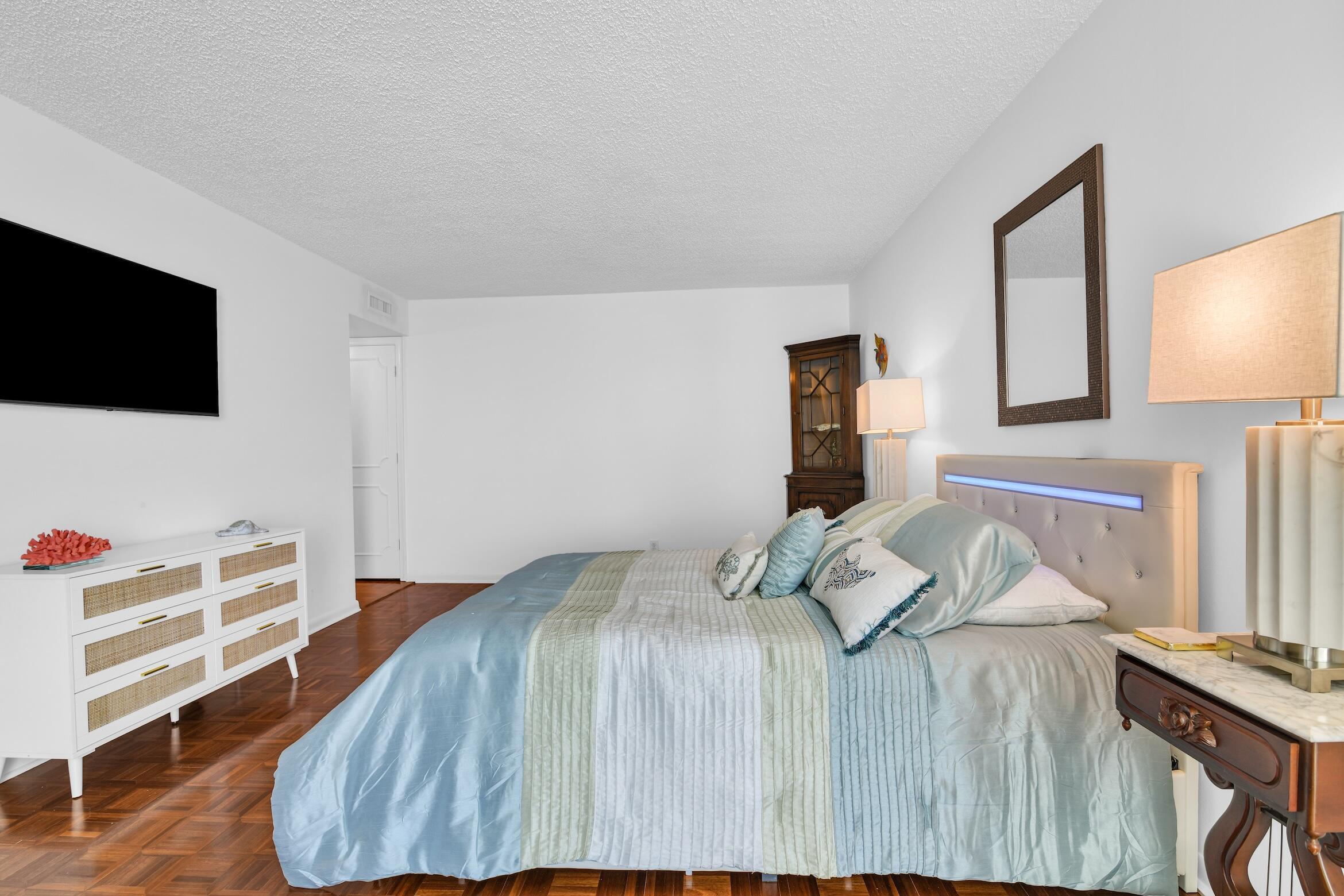 500 South Ocean Boulevard, Unit 1006 Boca Raton, FL 33432 - Photo 19 of 40 a bedroom with a bed and a flat screen tv
