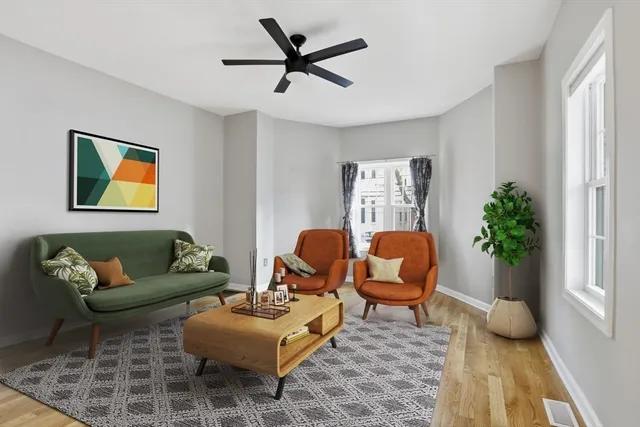 a living room with furniture and a potted plant