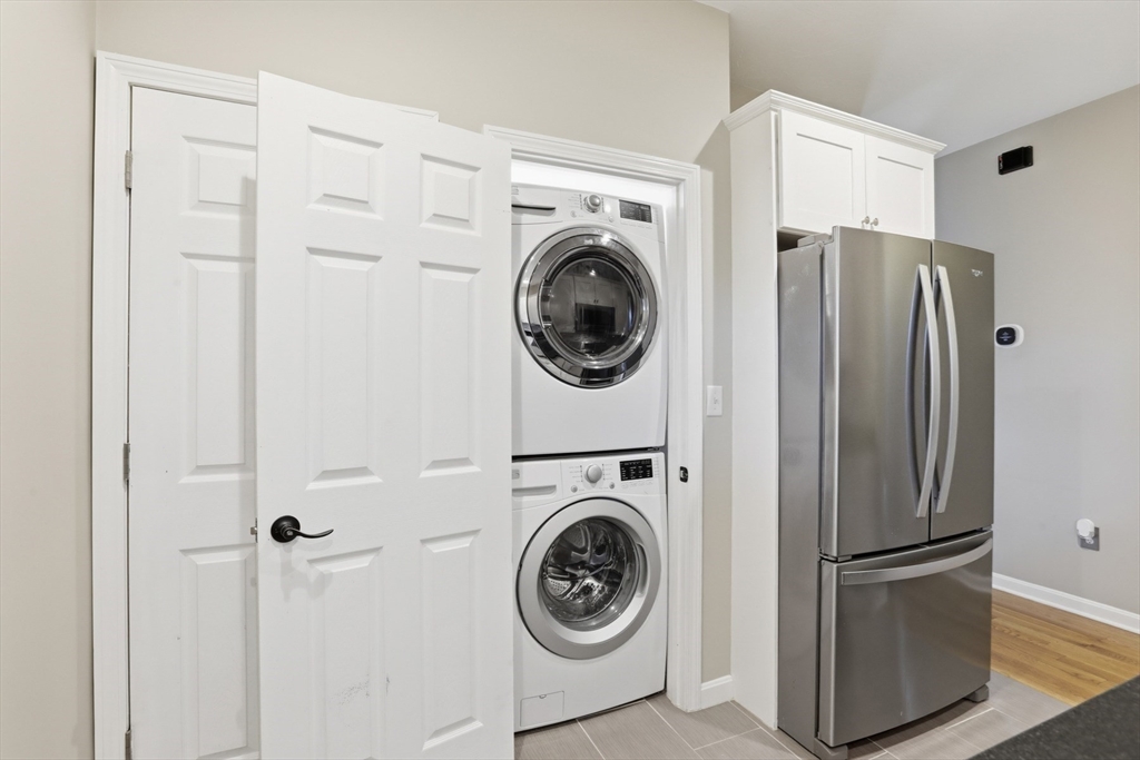 9 Montgomery Avenue, Unit 1 Somerville, MA 02145 - Photo 14 of 27 a view of a storage and utility room with washer and dryer