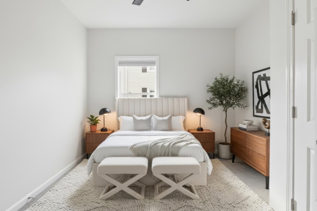 9 Montgomery Avenue, Unit 1 Somerville, MA 02145 - Photo 15 of 27 a bedroom with a bed and a chair