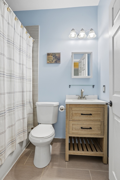9 Montgomery Avenue, Unit 1 Somerville, MA 02145 - Photo 20 of 27 a bathroom with a toilet sink and mirror