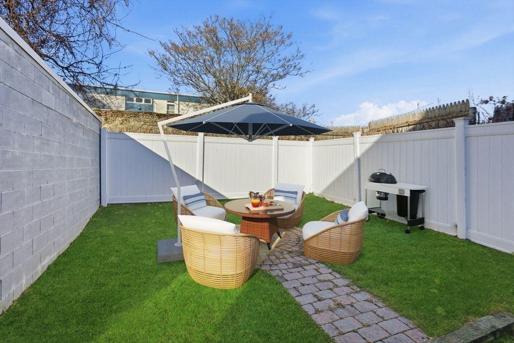 9 Montgomery Avenue, Unit 1 Somerville, MA 02145 - Photo 24 of 27 a view of a porch with furniture and a yard
