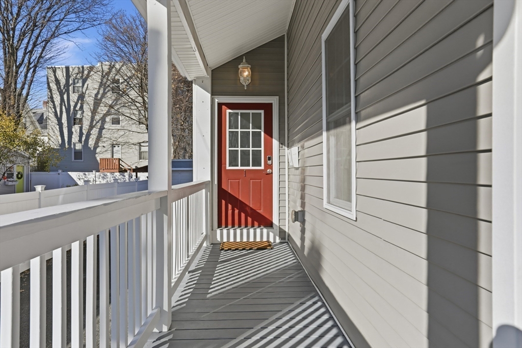 9 Montgomery Avenue, Unit 1 Somerville, MA 02145 - Photo 4 of 27 a view of a balcony with a potted plant and a window