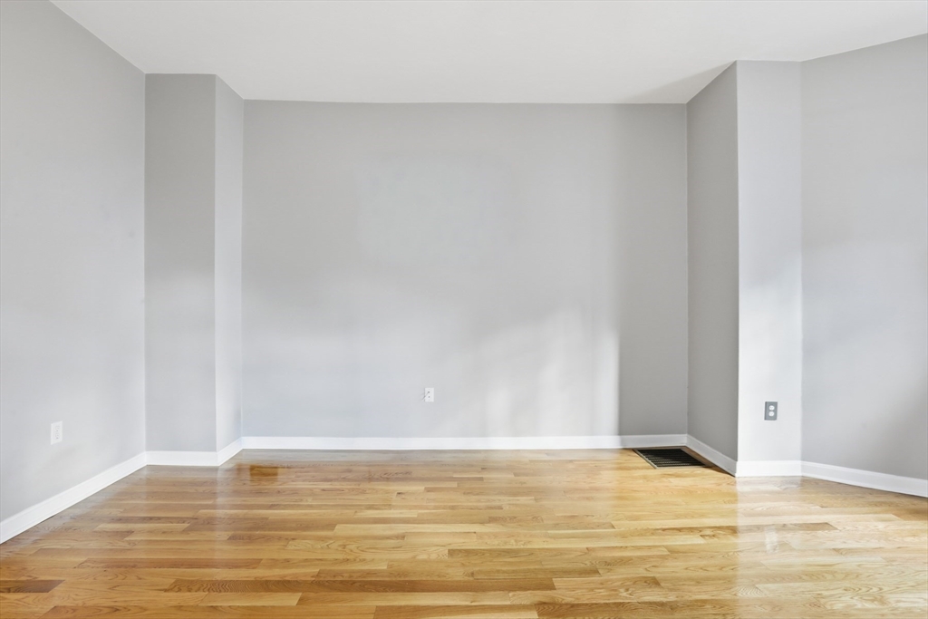 9 Montgomery Avenue, Unit 1 Somerville, MA 02145 - Photo 10 of 27 a view of an empty room and wooden floor