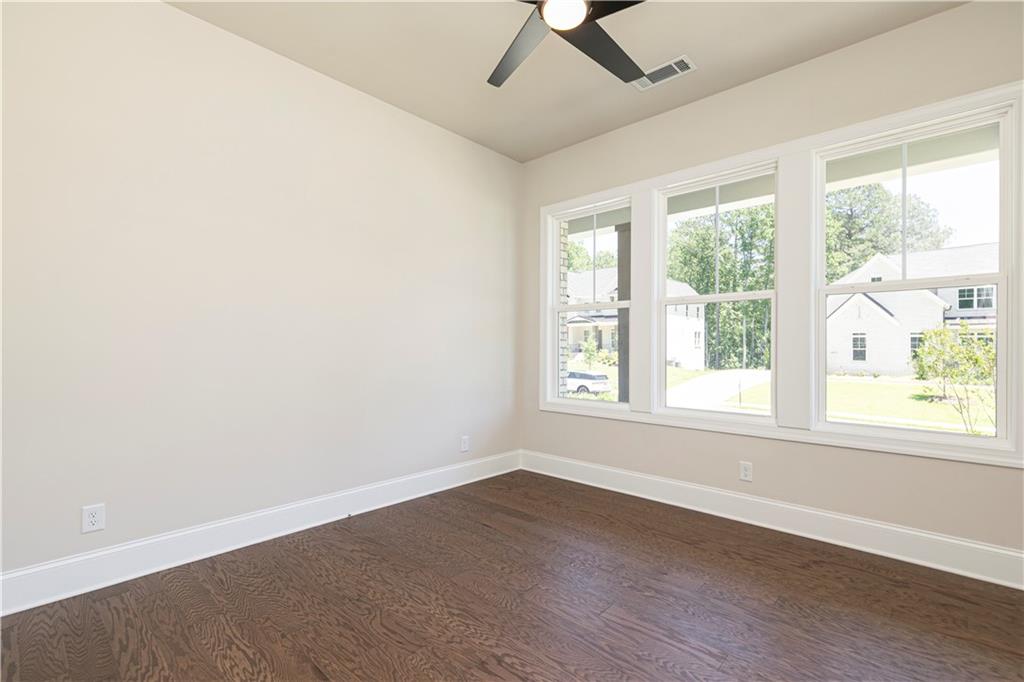 2475 Stewart Road Cumming, GA 30041 - Photo 14 of 30 an empty room with a window and wooden floor