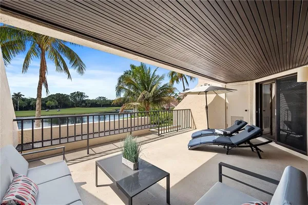 a view of a chairs and table in the balcony