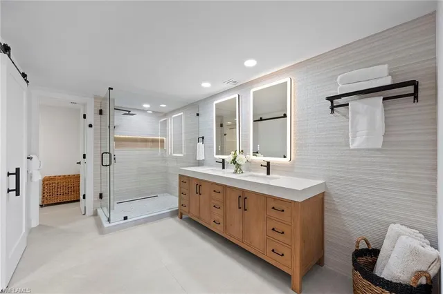 a kitchen with sink a refrigerator and chairs