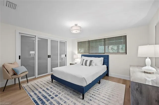 a bedroom with a bed and a chair