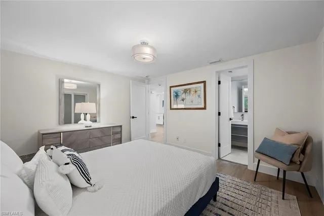 a bathroom with a sink a toilet a mirror and shower