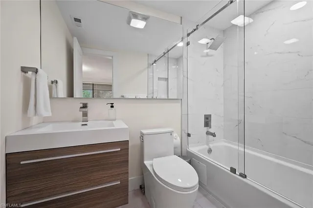 a view of a bedroom with a balcony a bed and a window