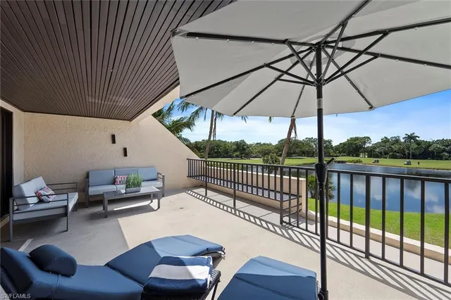 a view of a lake with a garden and swimming pool