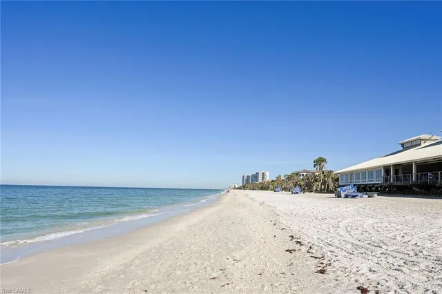 a view of an ocean beach and mountain