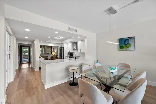 a living room with furniture and kitchen view