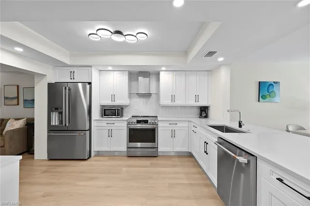 a kitchen with a sink stainless steel appliances and cabinets