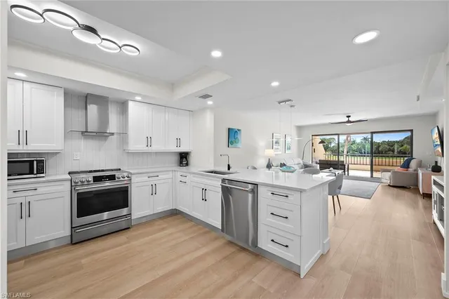 a living room with furniture and a large window with balcony view