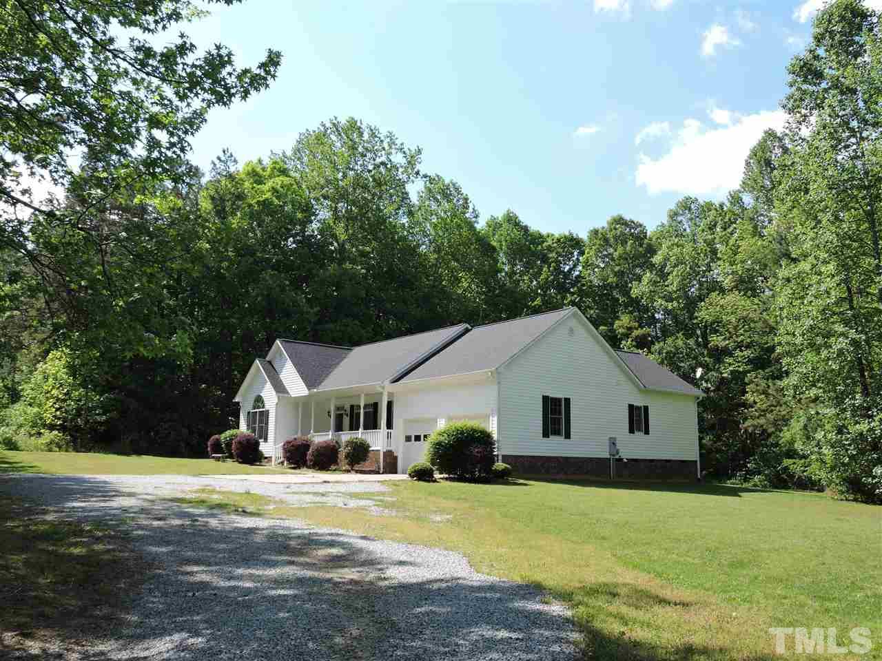 3360 Cates Mill Road Roxboro, NC 27574 - Photo 2 of 17 a front view of a house with a yard and trees