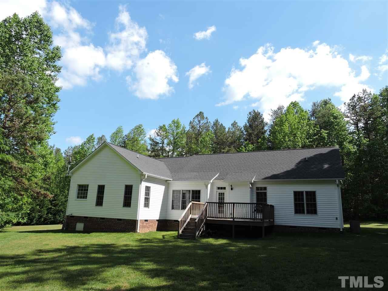 3360 Cates Mill Road Roxboro, NC 27574 - Photo 15 of 17 a front view of a house with a garden and yard