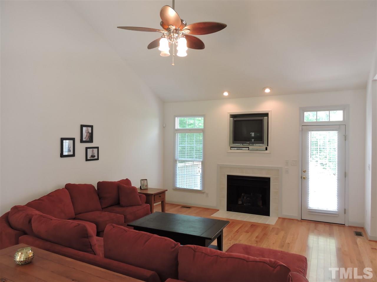3360 Cates Mill Road Roxboro, NC 27574 - Photo 7 of 17 a living room with furniture a fireplace and a flat screen tv