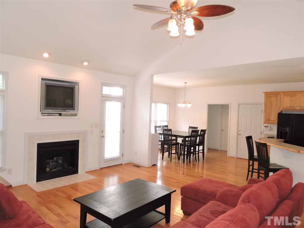 3360 Cates Mill Road Roxboro, NC 27574 - Photo 8 of 17 a living room with furniture a fireplace and a flat screen tv