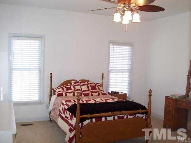 3360 Cates Mill Road Roxboro, NC 27574 - Photo 9 of 17 a bedroom with a bed and a window