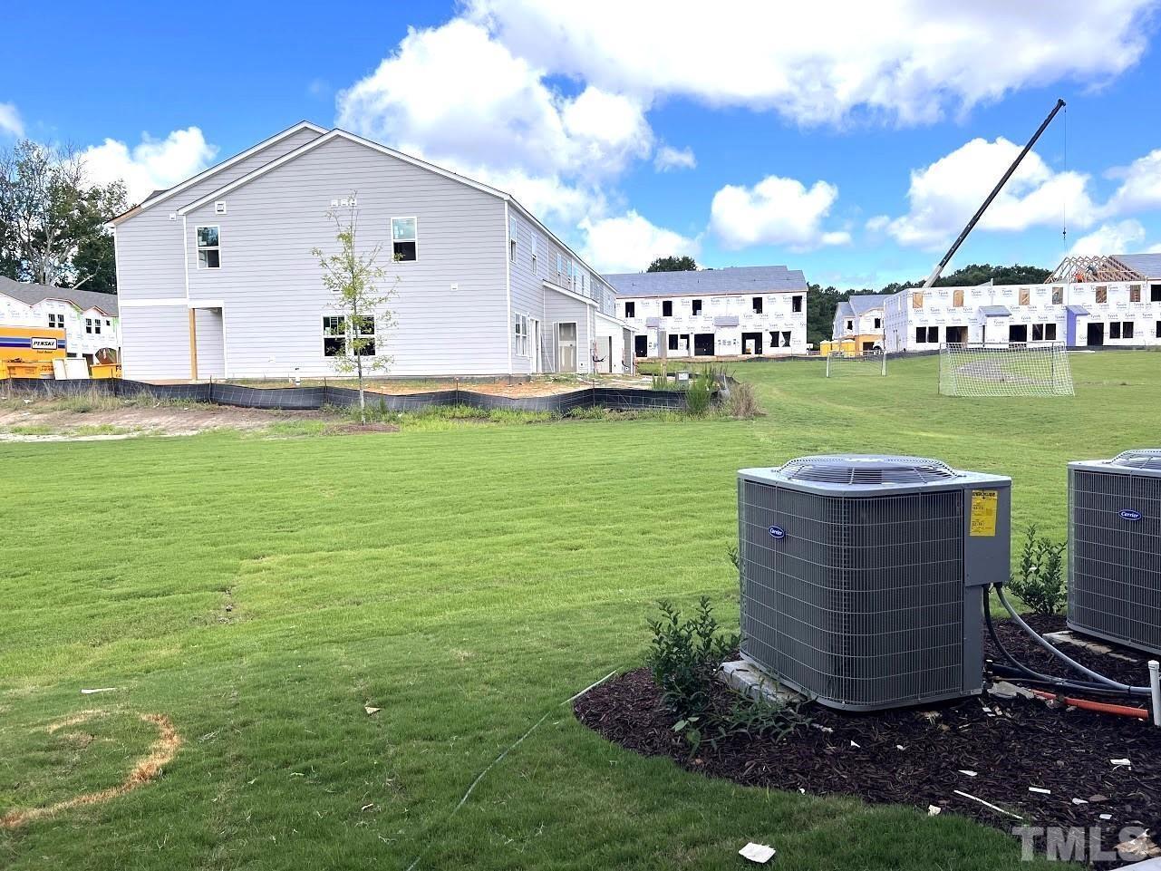 926 Field Ivy Drive Fuquay-Varina, NC 27526 - Photo 12 of 12 a view of a garden with lawn chairs