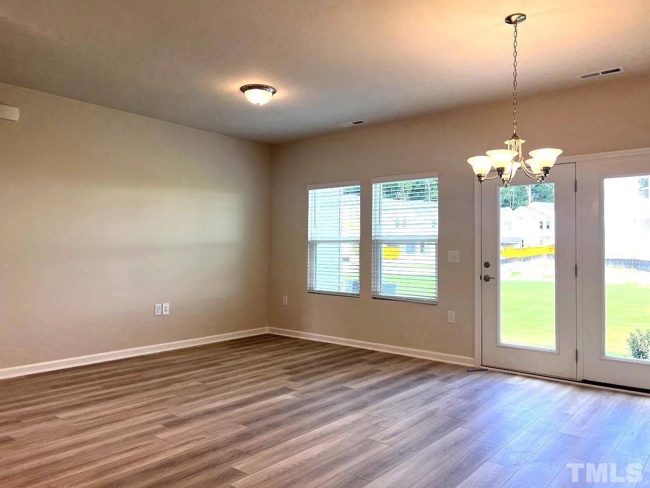926 Field Ivy Drive Fuquay-Varina, NC 27526 - Photo 3 of 12 a view of livingroom with hardwood floor and window