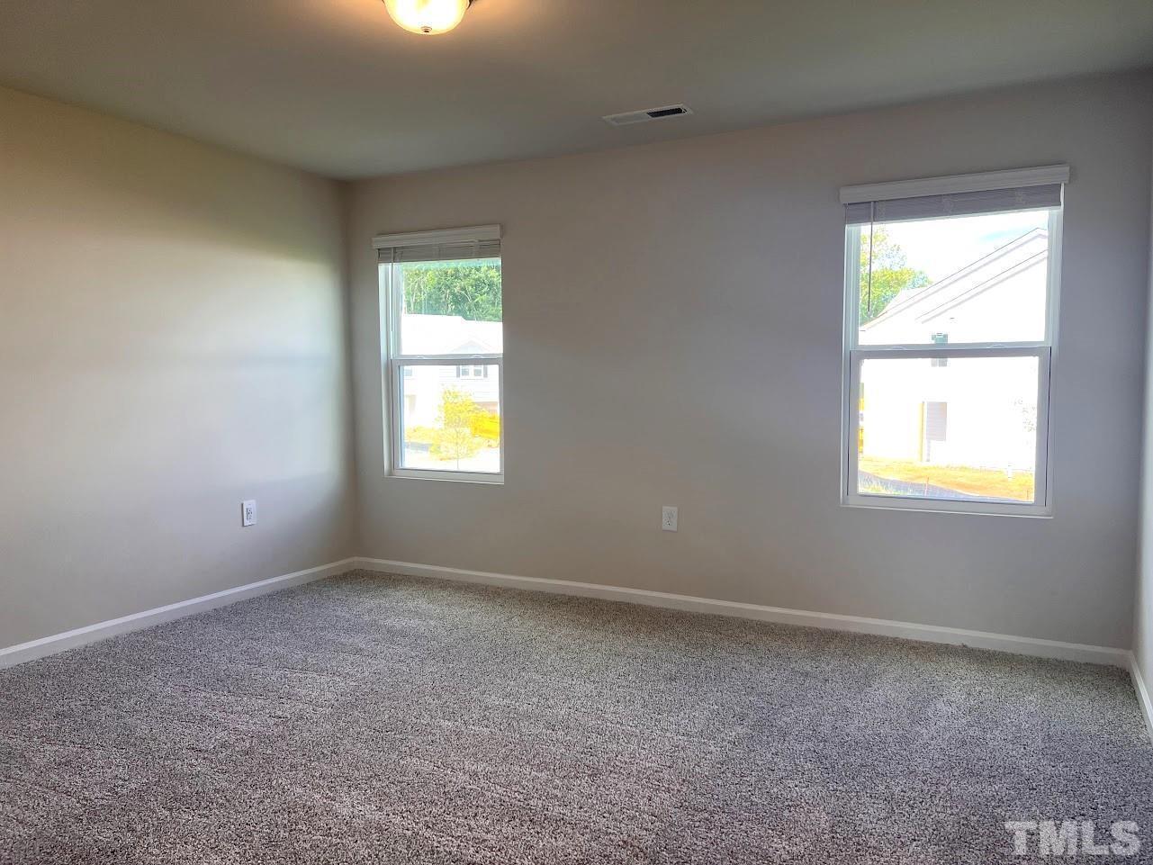 926 Field Ivy Drive Fuquay-Varina, NC 27526 - Photo 6 of 12 an empty room with a window
