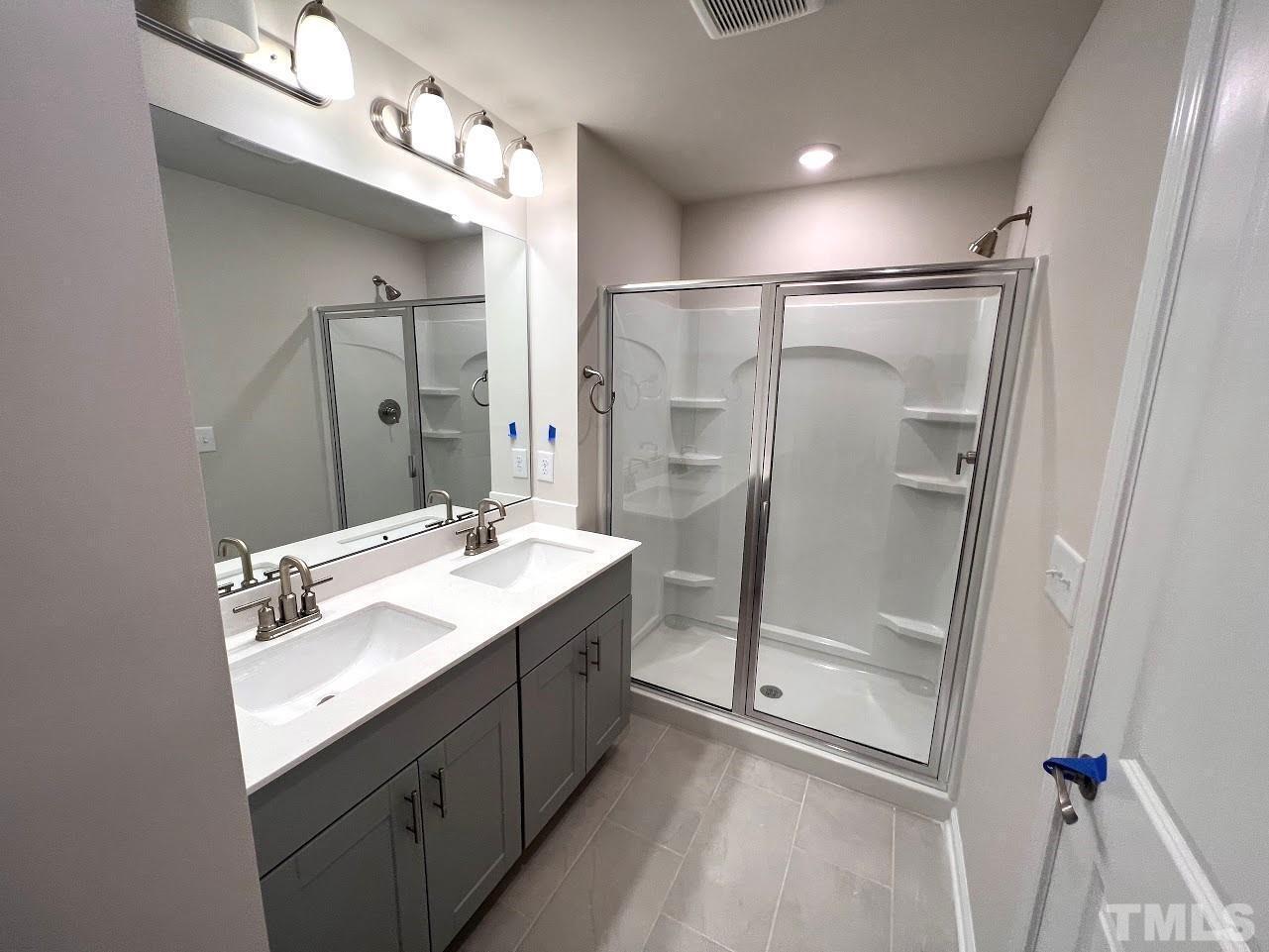 926 Field Ivy Drive Fuquay-Varina, NC 27526 - Photo 7 of 12 a bathroom with a double vanity sink mirror and shower