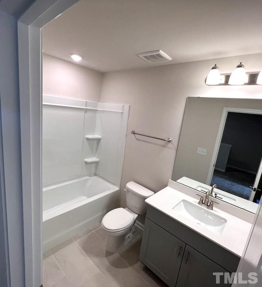 926 Field Ivy Drive Fuquay-Varina, NC 27526 - Photo 10 of 12 a bathroom with a sink a toilet and bathtub